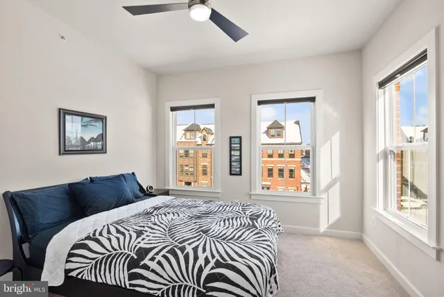a bedroom with a bed and a tv on table