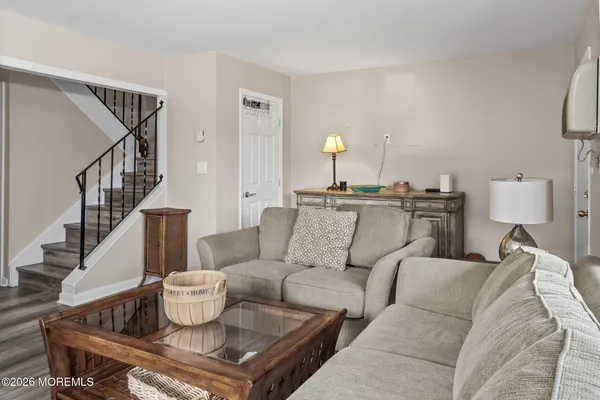 a living room with furniture and a book shelf