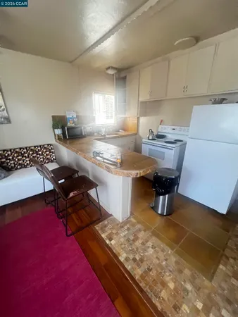 a kitchen with granite countertop a stove and a microwave