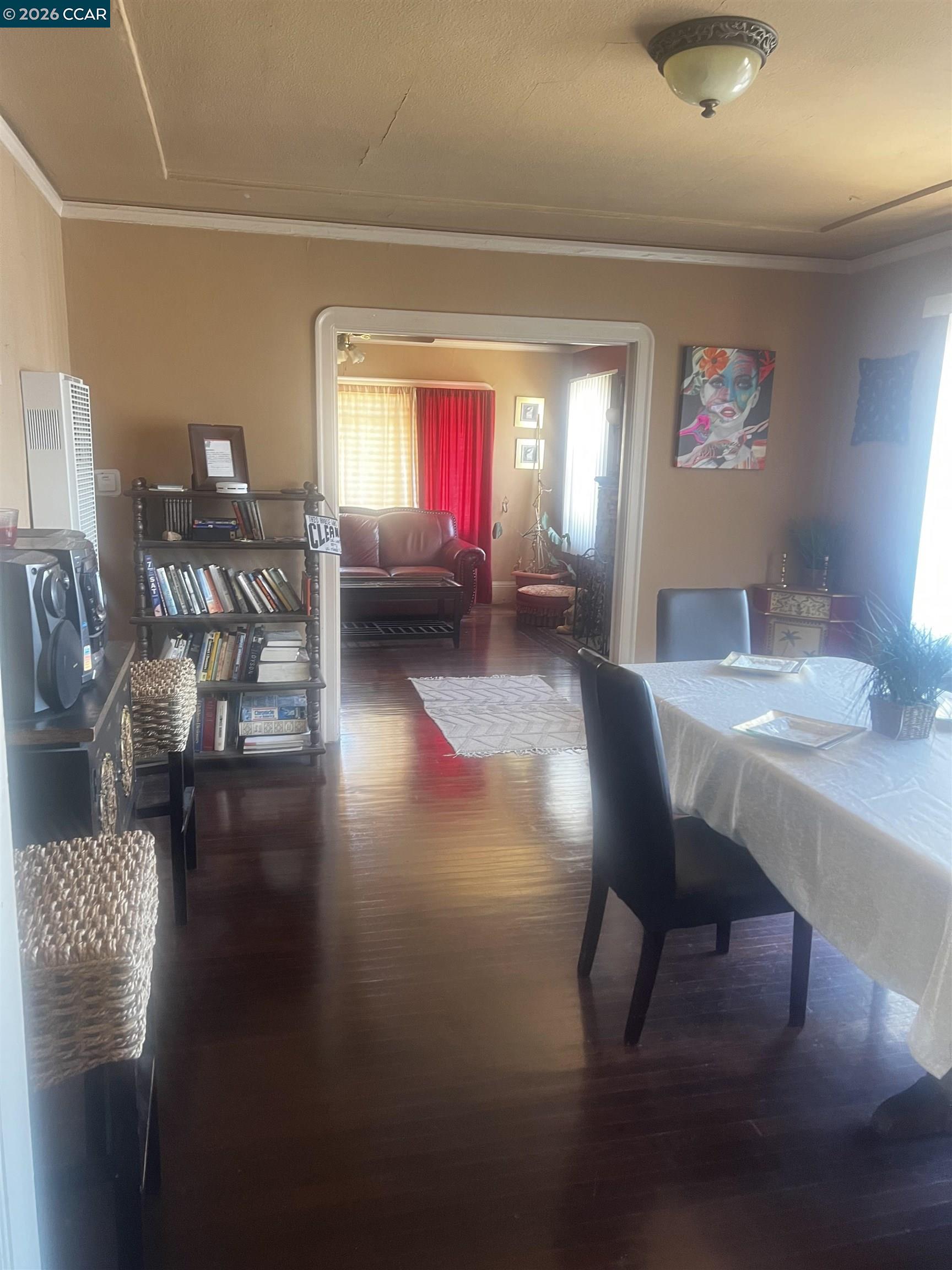 1161 64th Street Oakland, CA 94608 - Photo 24 of 25 a living room with furniture and a wooden floor