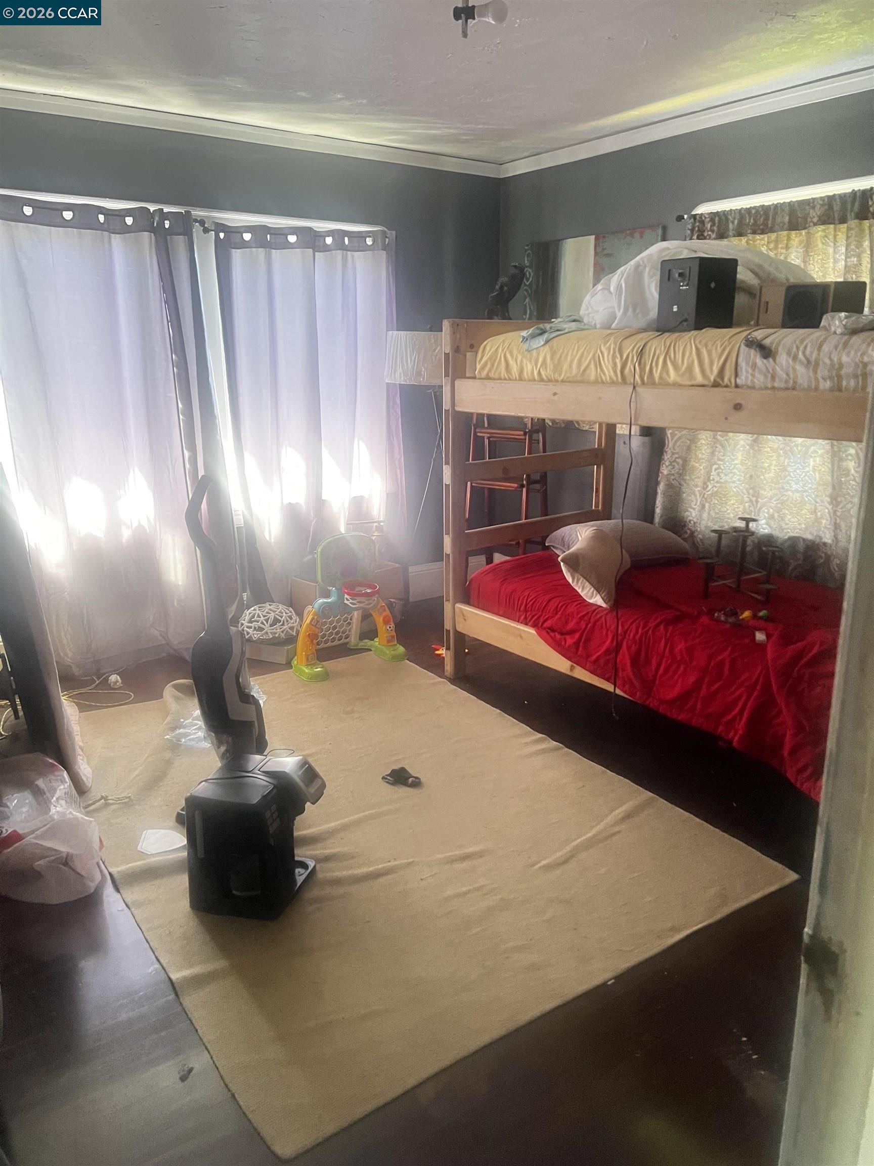 1161 64th Street Oakland, CA 94608 - Photo 25 of 25 a bedroom with a bed and window