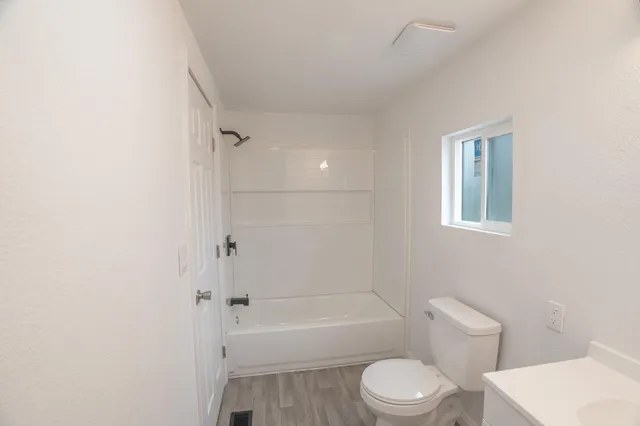 a bathroom with a toilet and a bath tub