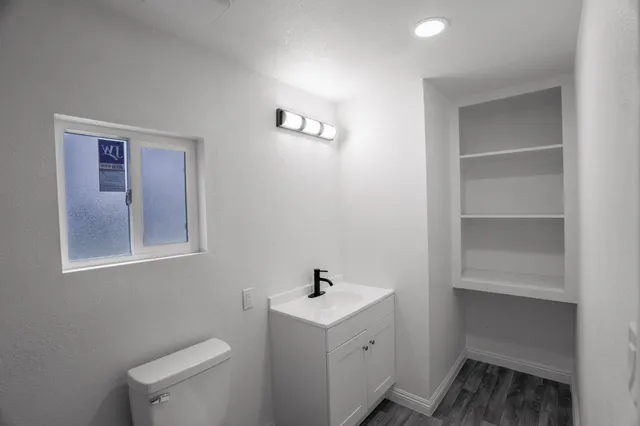 a white house with sink and mirror