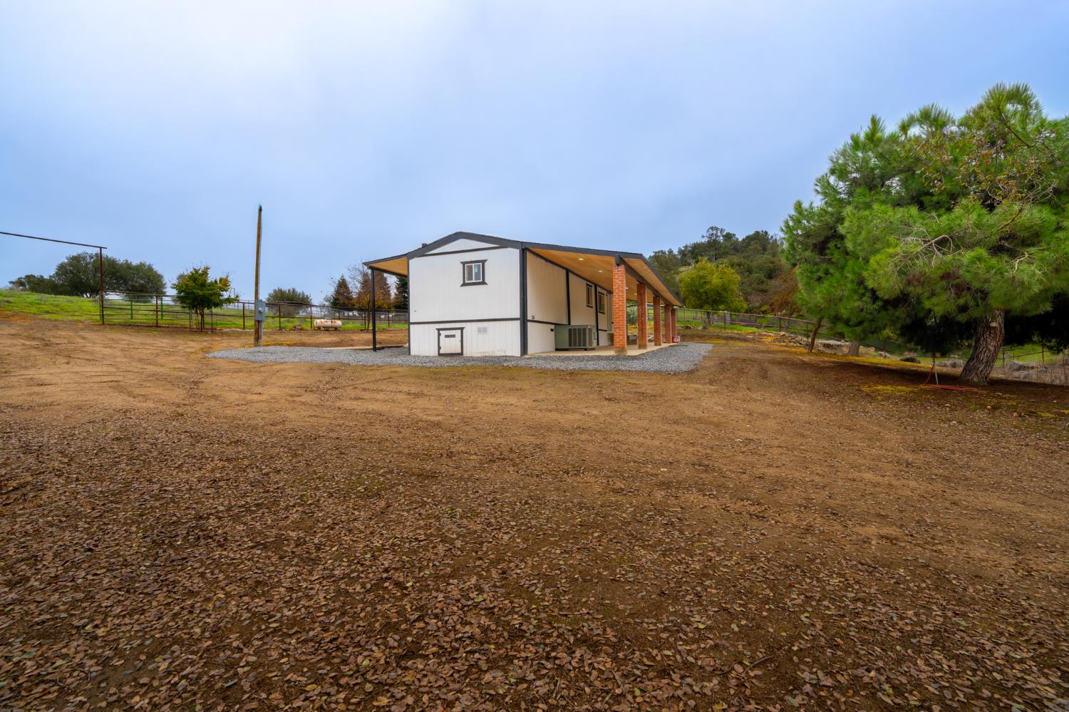 36712 Pebble Lane Squaw Valley, CA 93675 - Photo 16 of 17 a house with trees in front of it