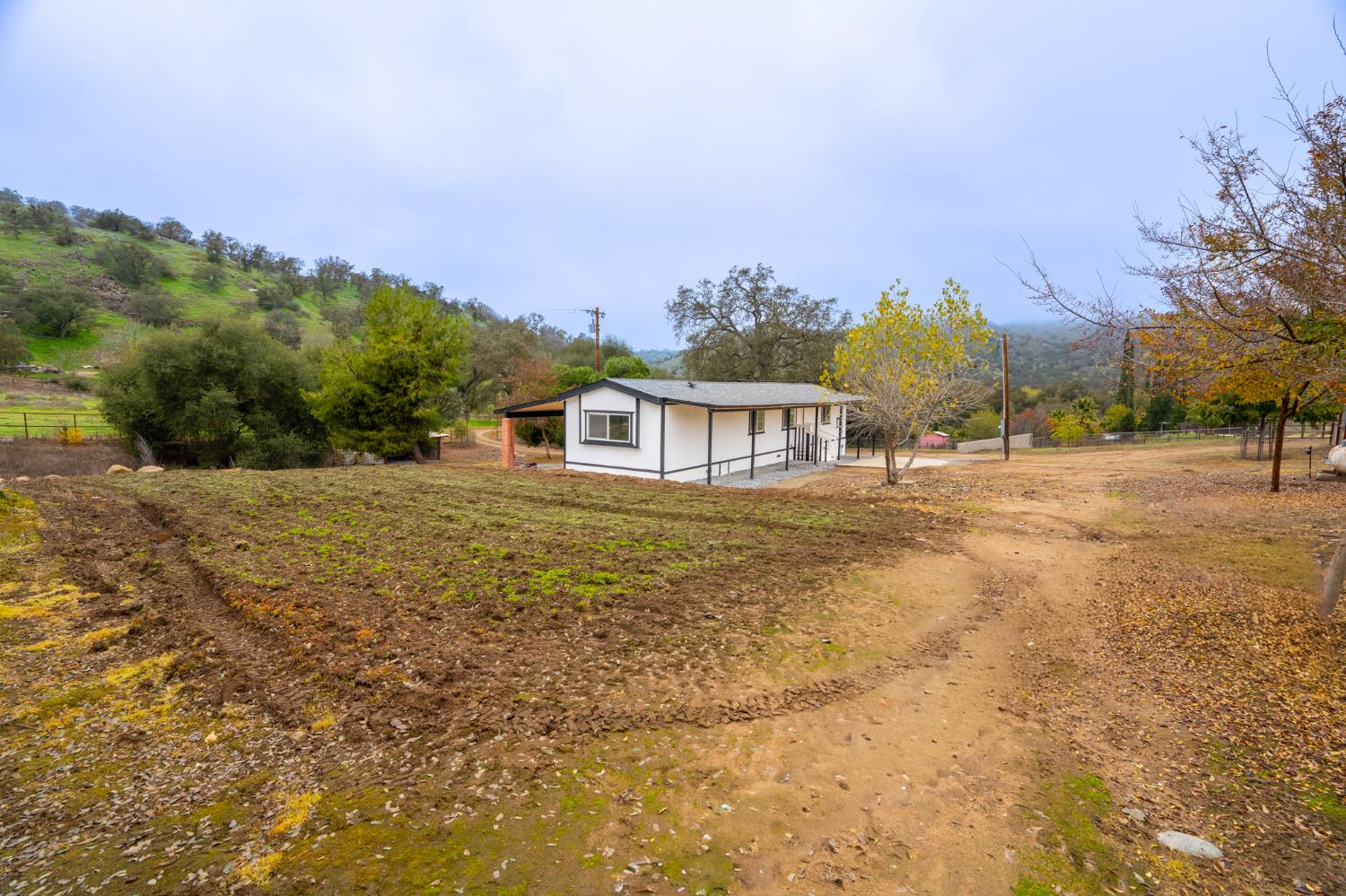 36712 Pebble Lane Squaw Valley, CA 93675 - Photo 17 of 17 a view of a house with a yard and sitting area