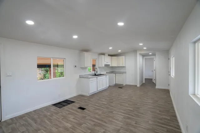 a view of kitchen with wooden floor and electronic appliances