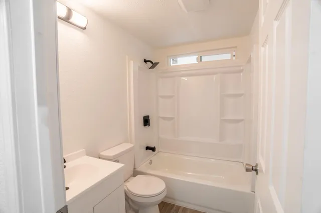 a bathroom with a shower a bathtub and a toilet