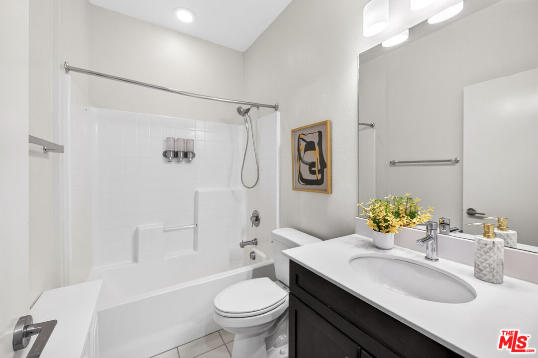 676 Colorado Circle Carson, CA 90745 - Photo 27 of 36 a bathroom with a sink toilet mirror and shower
