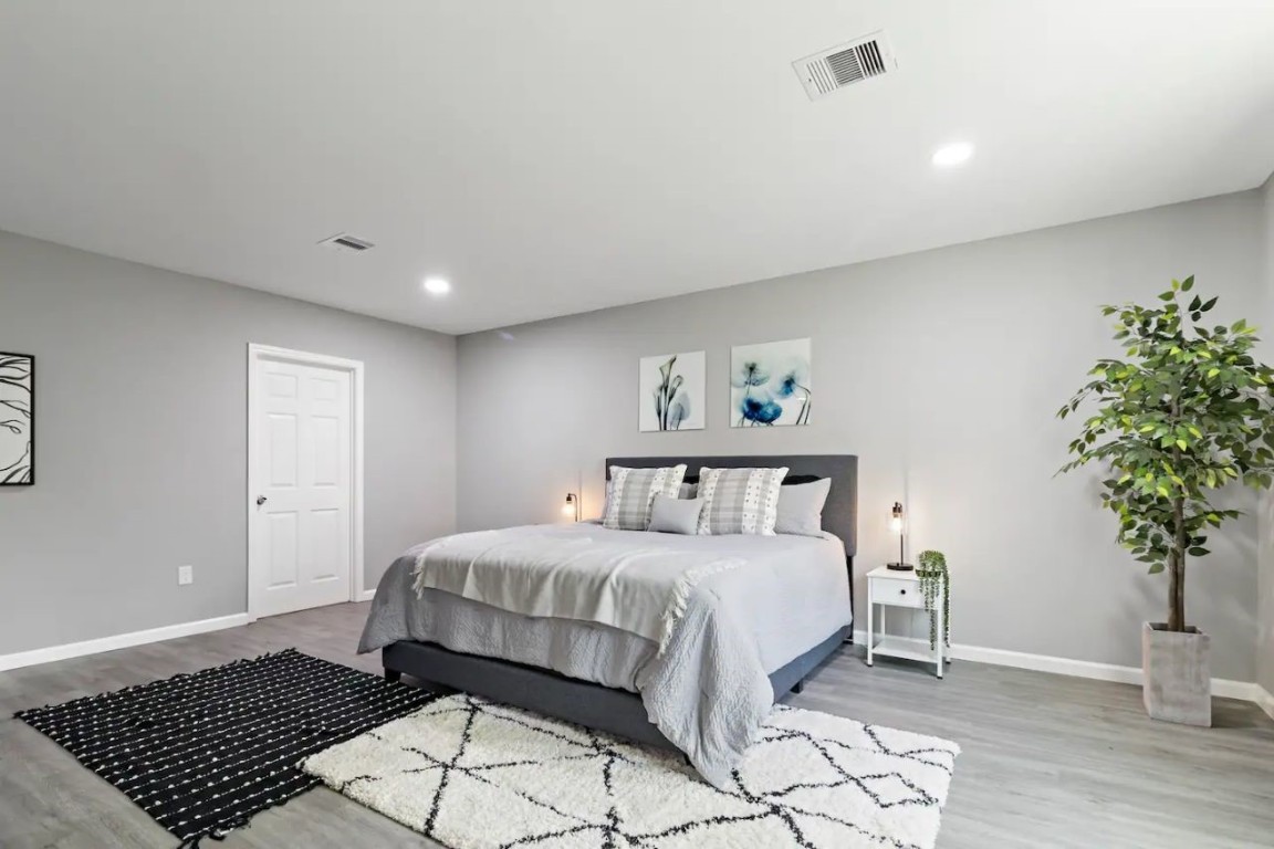 5130 Cosby Street Houston, TX 77021 - Photo 12 of 15 a bedroom with a bed and a potted plant