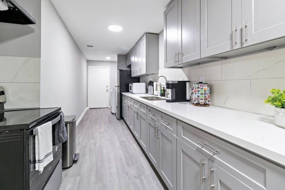 5130 Cosby Street Houston, TX 77021 - Photo 6 of 15 a kitchen with granite countertop a sink a stove and cabinets