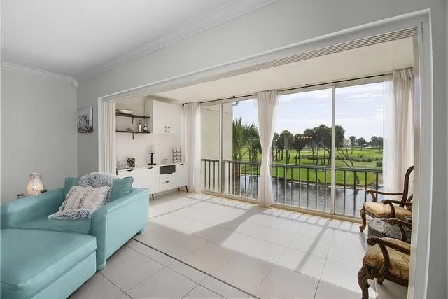 a living room with furniture and a floor to ceiling window