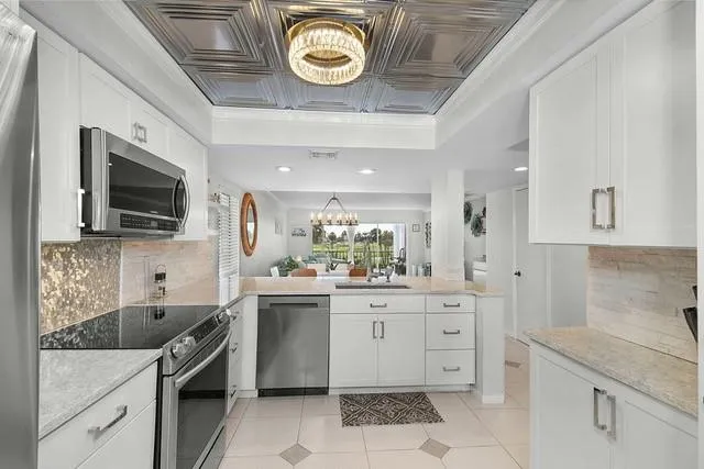 a kitchen with a sink and a stove top oven