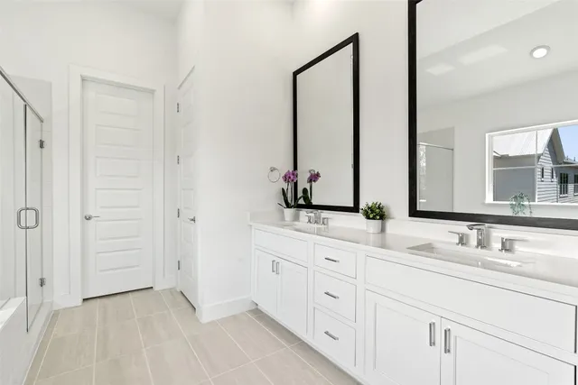 a bathroom with 2 sink and a mirror