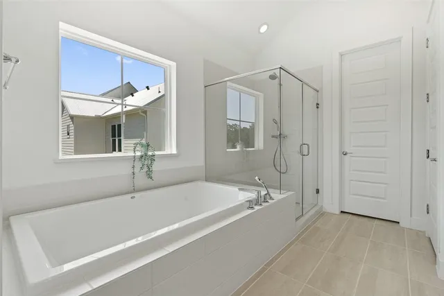 a white bath tub sitting next to a bathroom