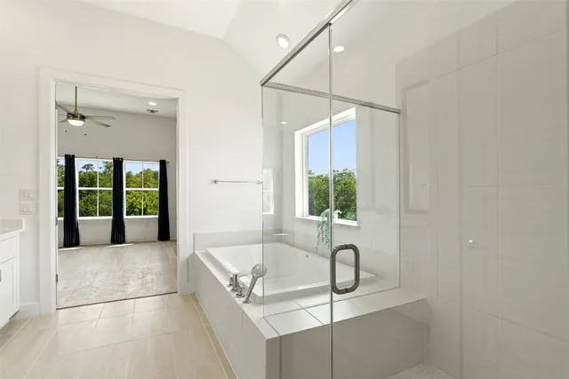 a bathroom with a tub sink and mirror