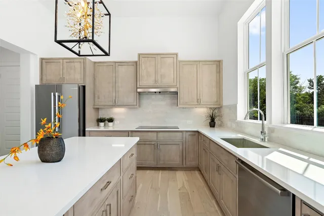 a kitchen with cabinets a sink and appliances