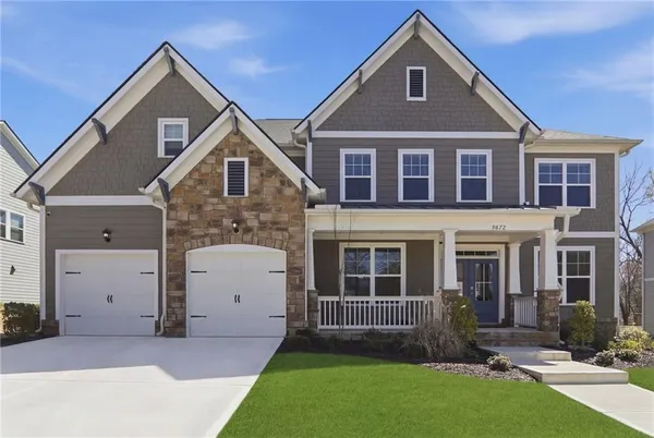a front view of a house with a yard and garage