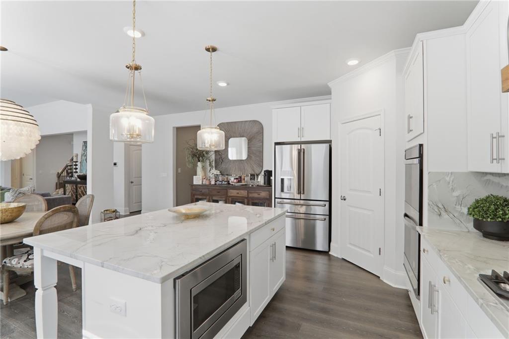 9872 Ashton Old Road Douglasville, GA 30135 - Photo 18 of 62 a large kitchen with stainless steel appliances kitchen island granite countertop a refrigerator a oven a island and a stove
