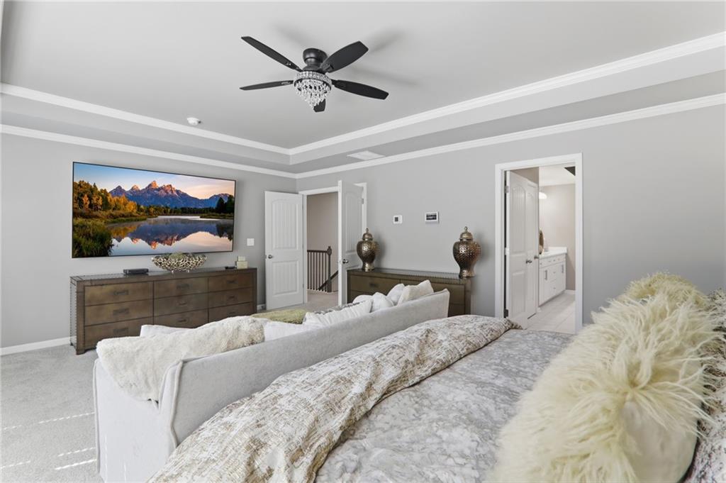 9872 Ashton Old Road Douglasville, GA 30135 - Photo 27 of 62 a bedroom with a large bed and a chandelier