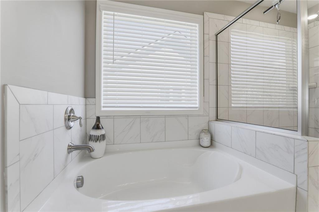 9872 Ashton Old Road Douglasville, GA 30135 - Photo 30 of 62 a white bath tub sitting in a bathroom next to a window