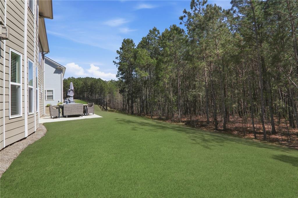 9872 Ashton Old Road Douglasville, GA 30135 - Photo 46 of 62 a view of a patio with table and chairs and wooden fence
