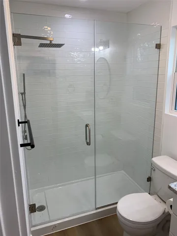 a bathroom with a toilet and a shower