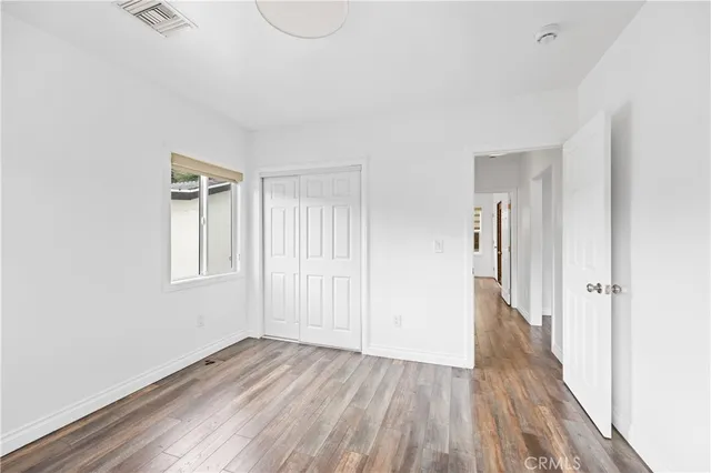 a view of a livingroom with wooden floor and window
