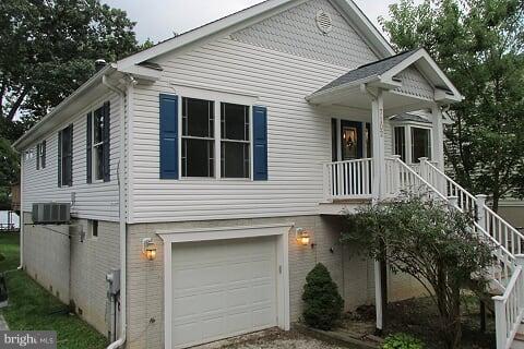 7102 Greenbank Road Baltimore, MD 21220 - Photo 2 of 30 a front view of a house with a yard and garage