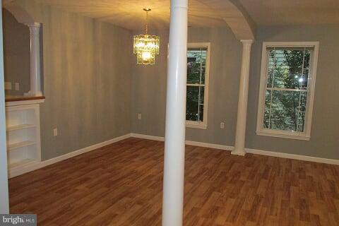 7102 Greenbank Road Baltimore, MD 21220 - Photo 11 of 30 an empty room with wooden floor and windows
