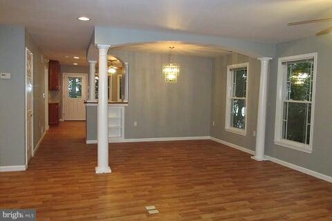 7102 Greenbank Road Baltimore, MD 21220 - Photo 12 of 30 a view of a hallway with wooden floor and a bathroom