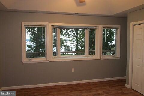 7102 Greenbank Road Baltimore, MD 21220 - Photo 13 of 30 a view of an empty room with wooden floor and a window