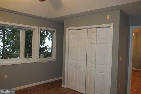 7102 Greenbank Road Baltimore, MD 21220 - Photo 14 of 30 a view of an empty room with wooden floor and a window