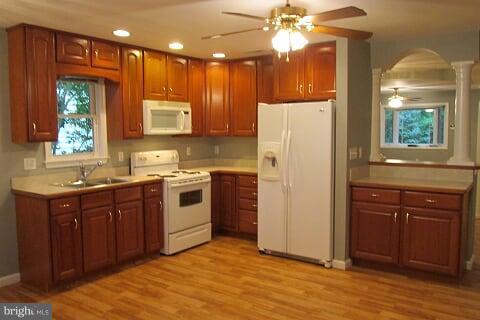 7102 Greenbank Road Baltimore, MD 21220 - Photo 7 of 30 a kitchen with a refrigerator sink and cabinets