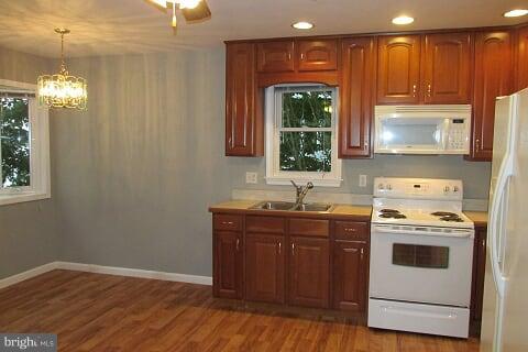 7102 Greenbank Road Baltimore, MD 21220 - Photo 8 of 30 a kitchen with a stove a sink and a window