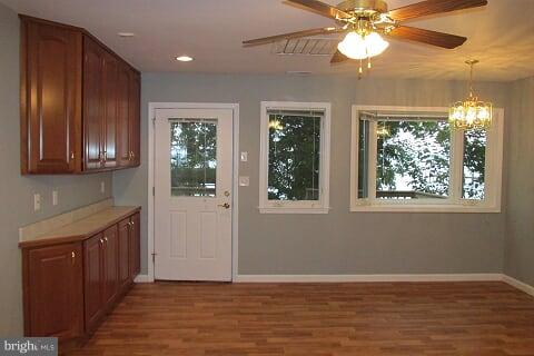 7102 Greenbank Road Baltimore, MD 21220 - Photo 9 of 30 an empty room with wooden floor fan and windows