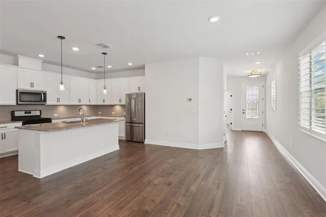 a view of kitchen with wooden floor and window