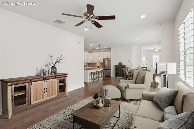 a living room with furniture kitchen view and a fireplace