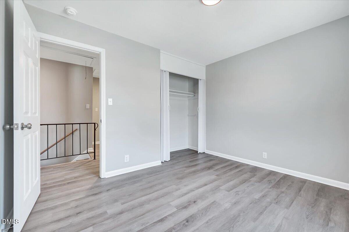 3408 Atlantic Avenue Raleigh, NC 27604 - Photo 40 of 48 a view of an empty room with wooden floor and a window