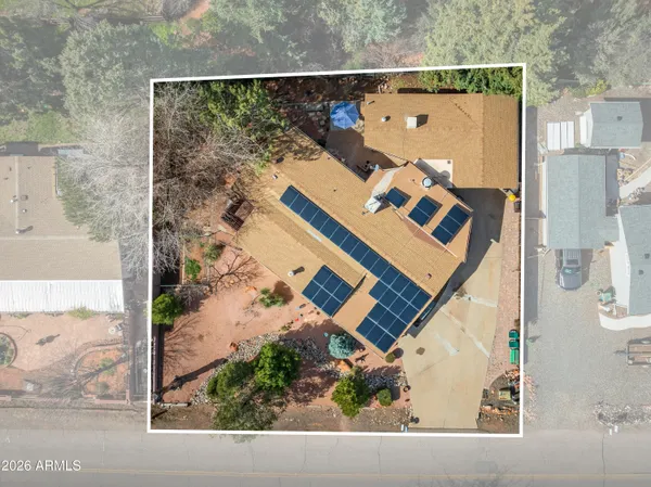 an aerial view of a house with a yard