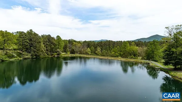 a view of a lake with a house in the background