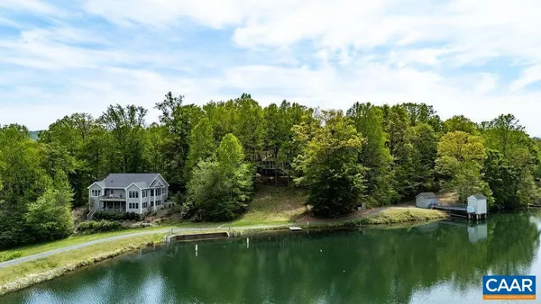 a view of a lush green forest with a house