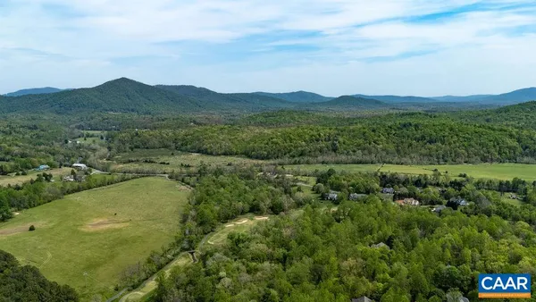 an aerial view of houses covered in trees