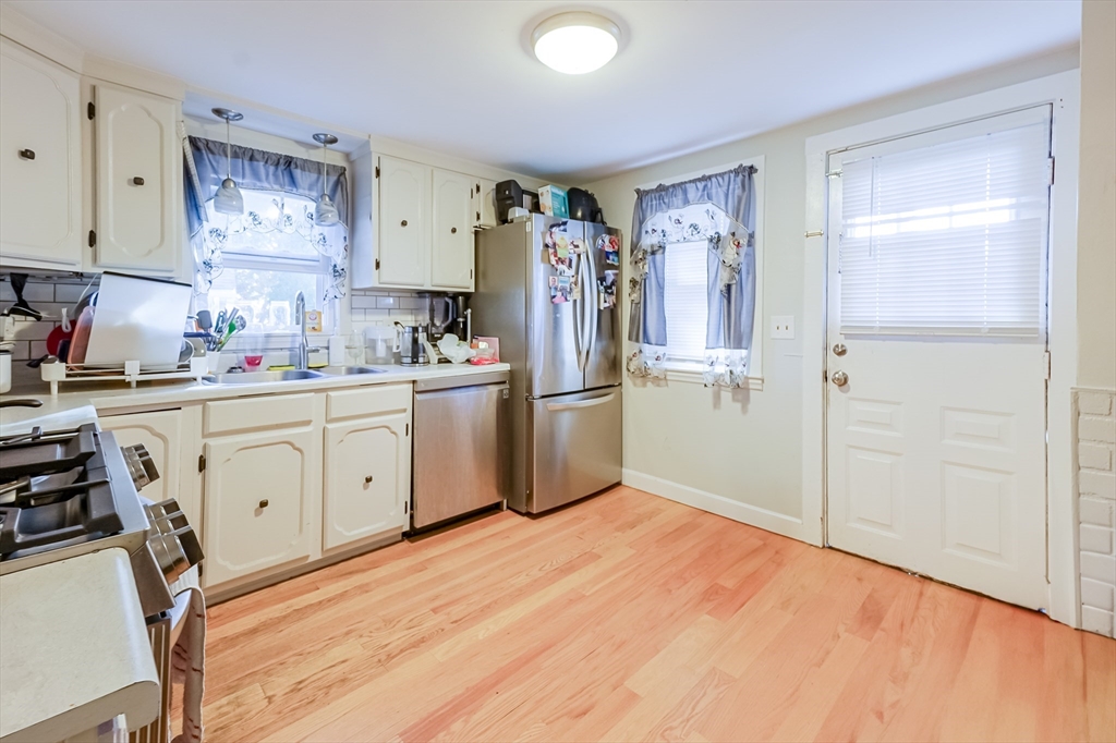 5 Oliver Street Randolph, MA 02368 - Photo 13 of 29 a kitchen with stainless steel appliances a refrigerator sink and cabinets