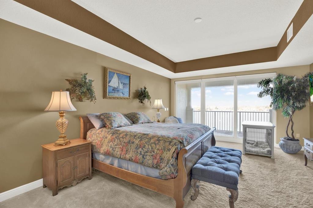 17745 Gulf Boulevard, Unit 604 Redington Shores, FL 33708 - Photo 14 of 44 a bedroom with a bed lamp and a large window