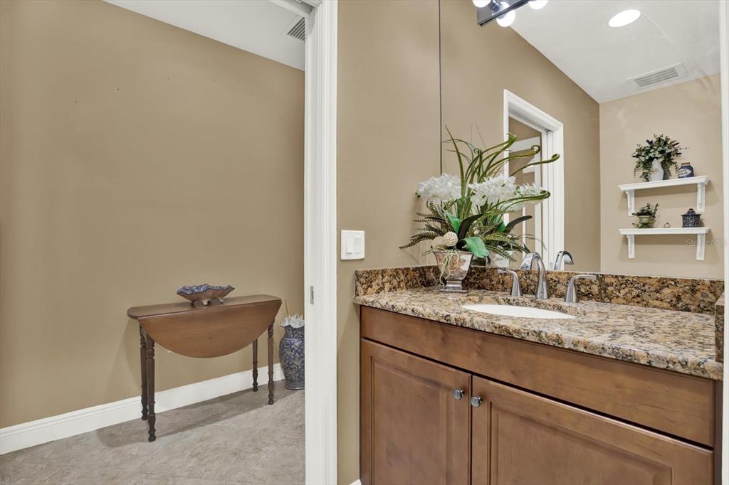17745 Gulf Boulevard, Unit 604 Redington Shores, FL 33708 - Photo 21 of 44 a bathroom with a granite countertop sink and a mirror