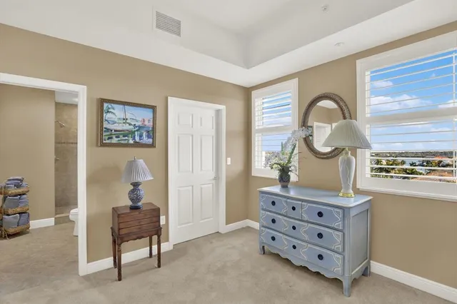 a room with furniture and paintings on the wall