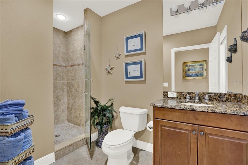 17745 Gulf Boulevard, Unit 604 Redington Shores, FL 33708 - Photo 25 of 44 a bathroom with a granite countertop toilet sink and a mirror