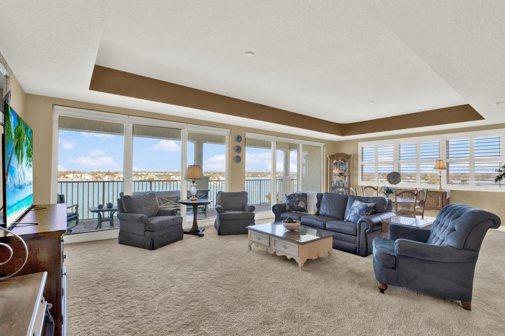 17745 Gulf Boulevard, Unit 604 Redington Shores, FL 33708 - Photo 3 of 44 a living room with furniture and a floor to ceiling window