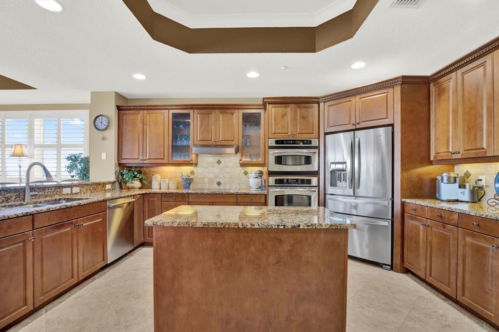 17745 Gulf Boulevard, Unit 604 Redington Shores, FL 33708 - Photo 6 of 44 a large kitchen with stainless steel appliances granite countertop a refrigerator and a sink