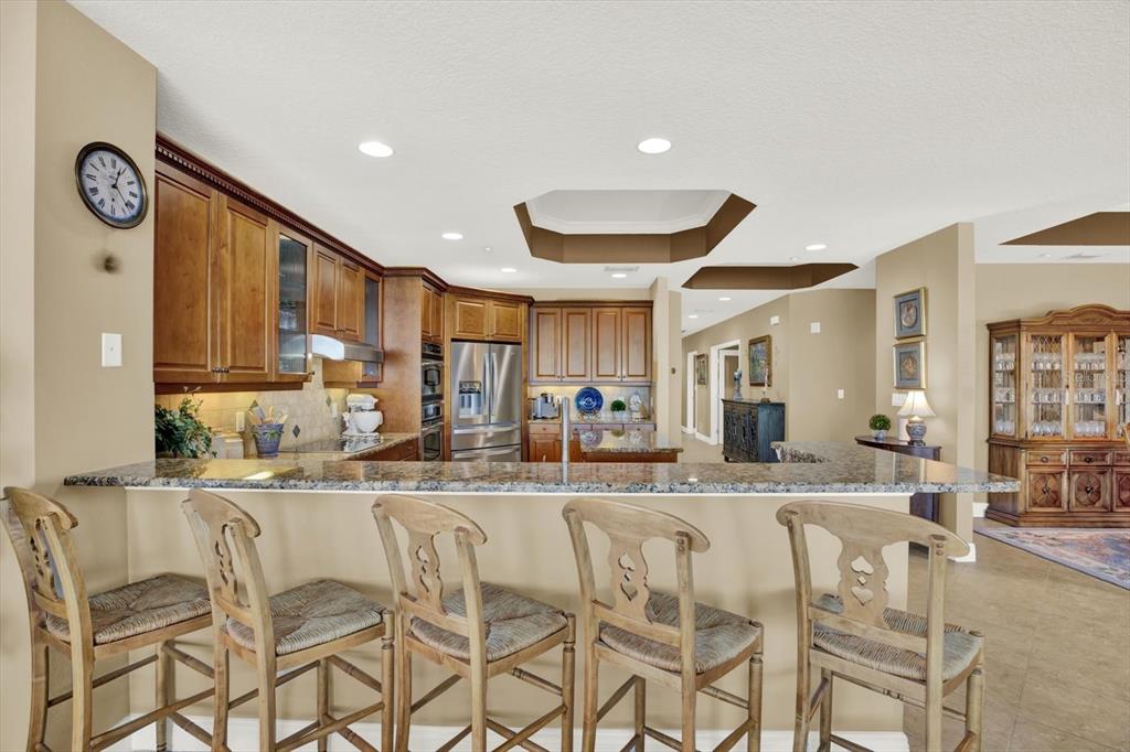 17745 Gulf Boulevard, Unit 604 Redington Shores, FL 33708 - Photo 9 of 44 a dining hall with stainless steel appliances granite countertop a dining table and chairs